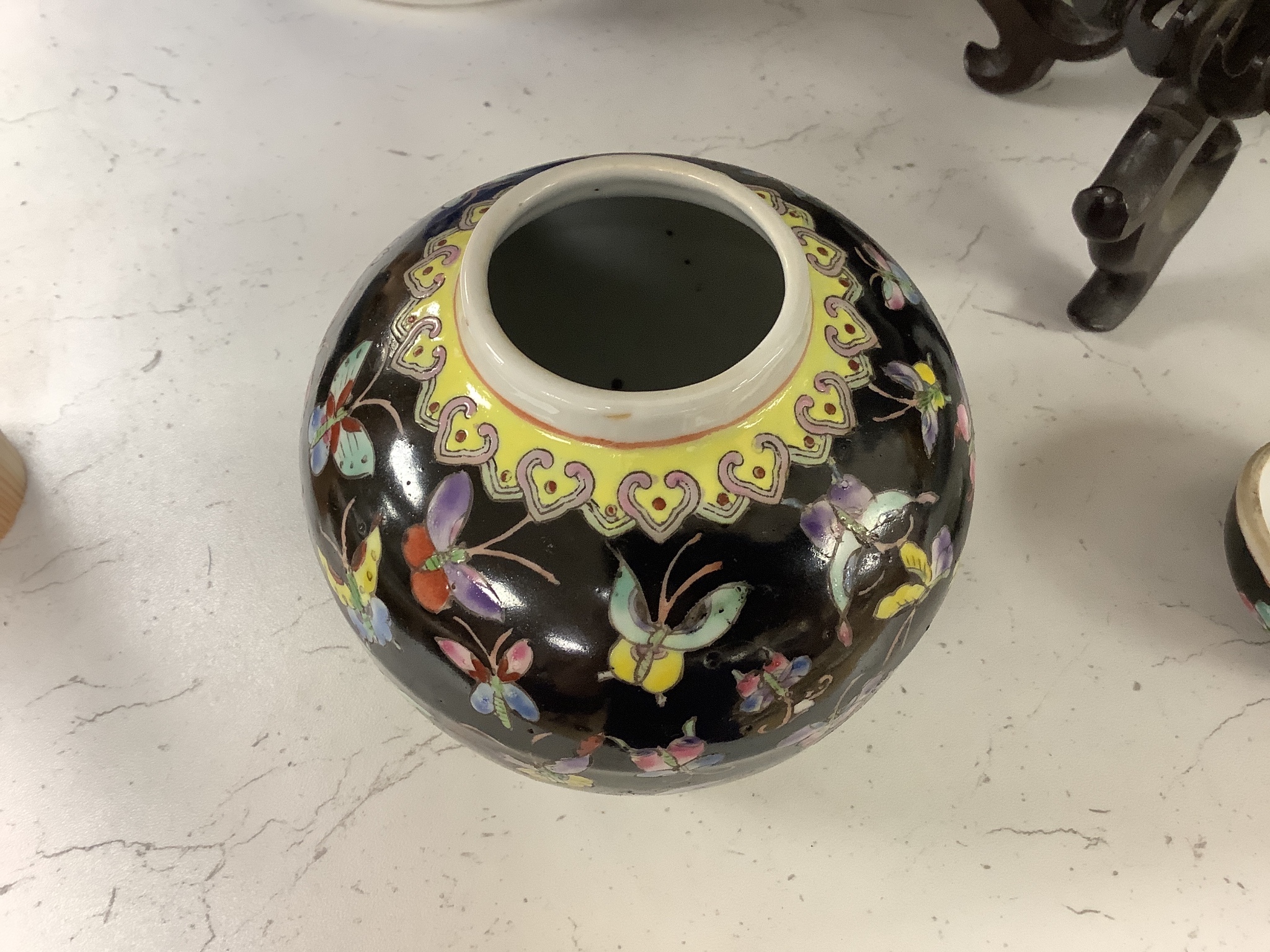 A 19th century Chinese porcelain prunus jar and cover, 27cm, on carved wood stand, a smaller famille noire jar and cover, a Chinese export fruit bowl, blue and white dish and a similar jar and cover 27cm